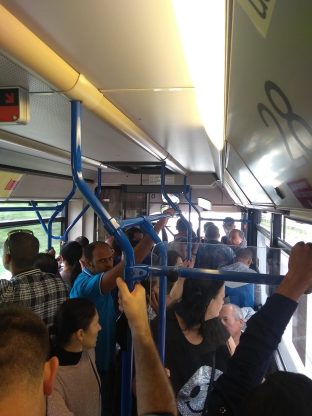 peobple on a jamcrowded bus